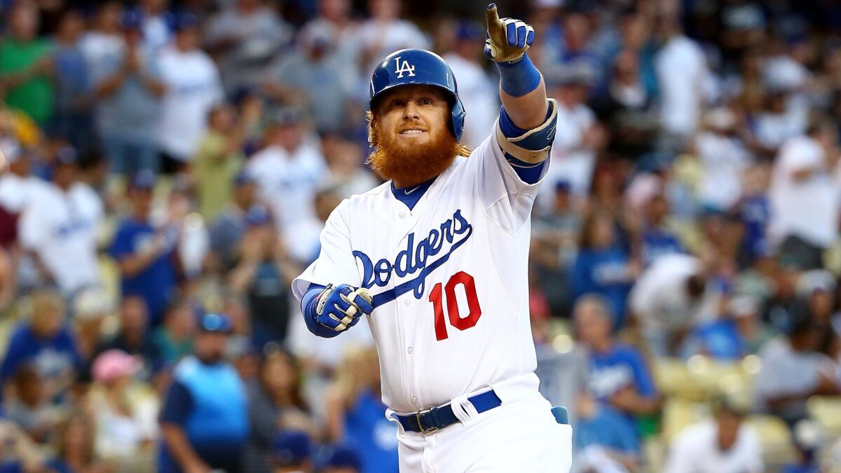 Dodgers third baseman Justin Turner points to the stands after hitting a solo home run against the Padres in the first inning Satuday evening.