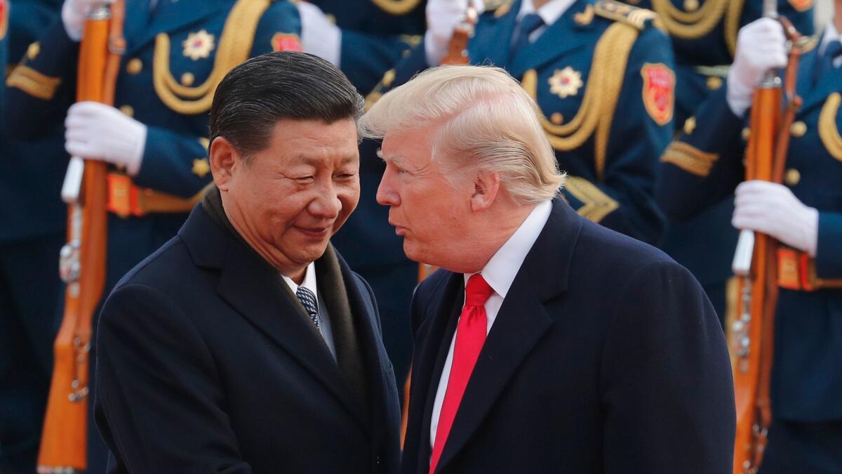 President Trump chats with Chinese President Xi Jinping in Beijing on Nov. 9.