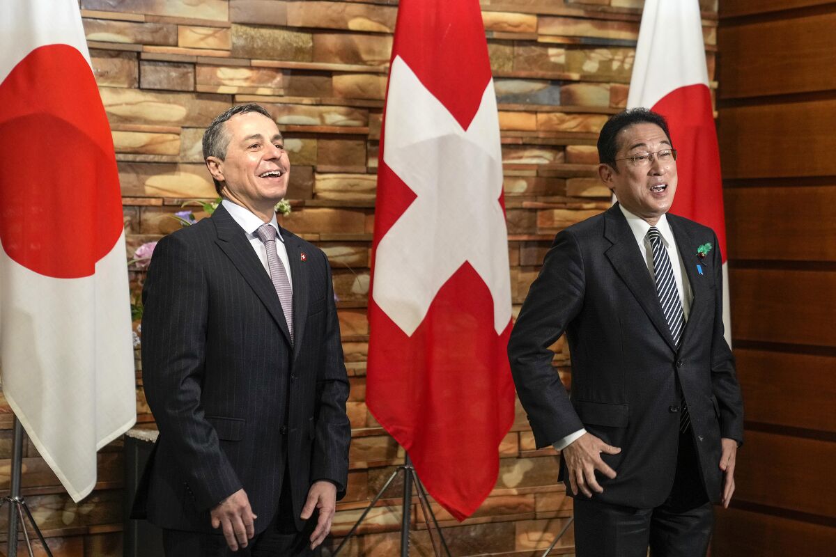 Swiss President Ignazio Cassis, left, and Japanese Prime Minister Fumio Kishida pose for media before their meeting at the Prime Minister's residence in Tokyo, Monday, April 18, 2022. (Kimimasa Mayama/Pool Photo via AP)