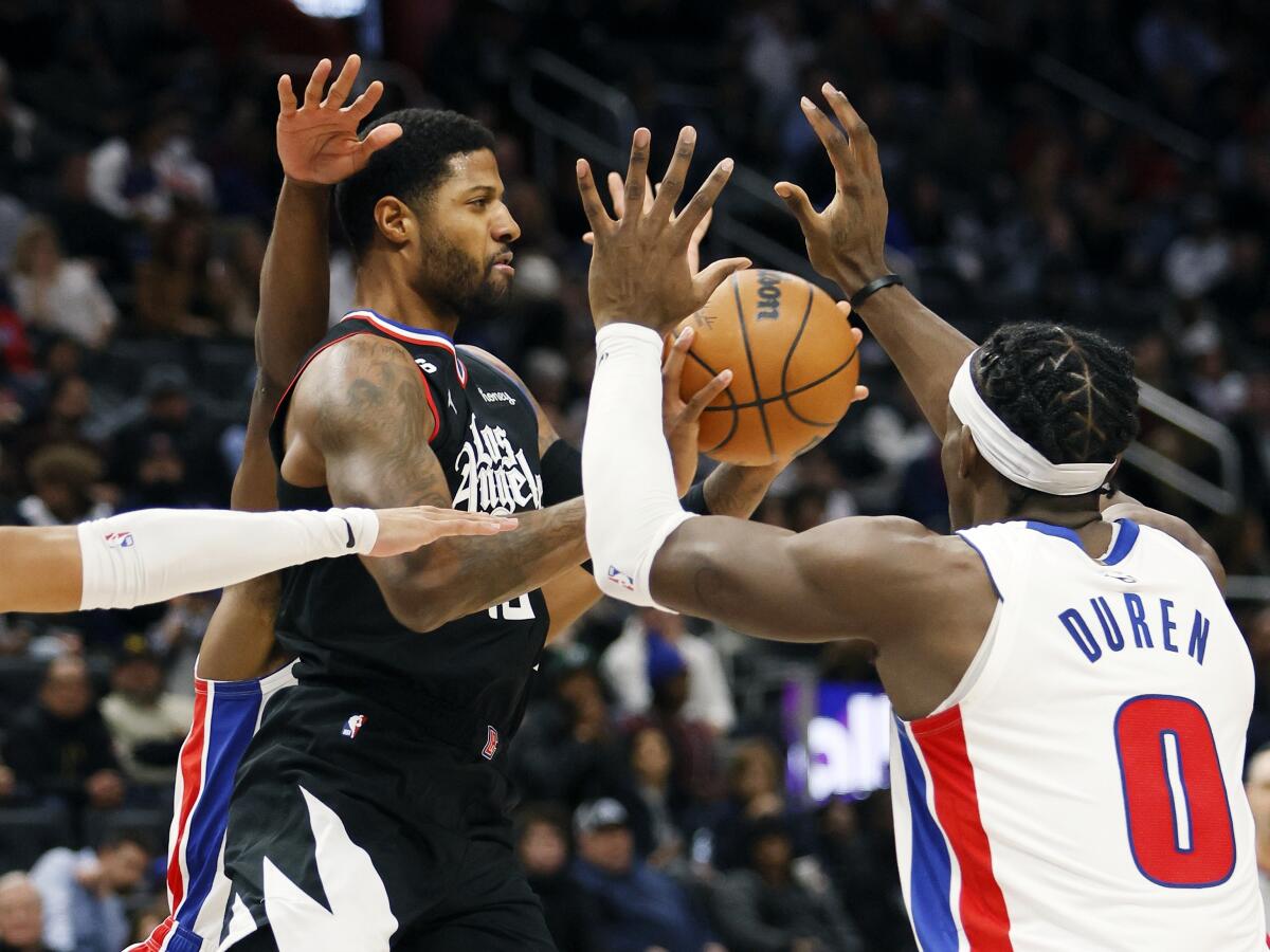 Clippers guard Paul George passes the ball against Detroit Pistons center Jalen Duren.