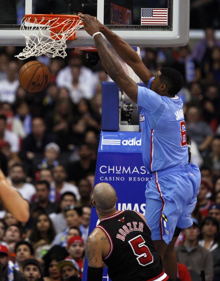 Clippers center DeAndre Jordan rises for a dunk above Bulls power forward Carlos Boozer in the second half Sunday at Staples Center.