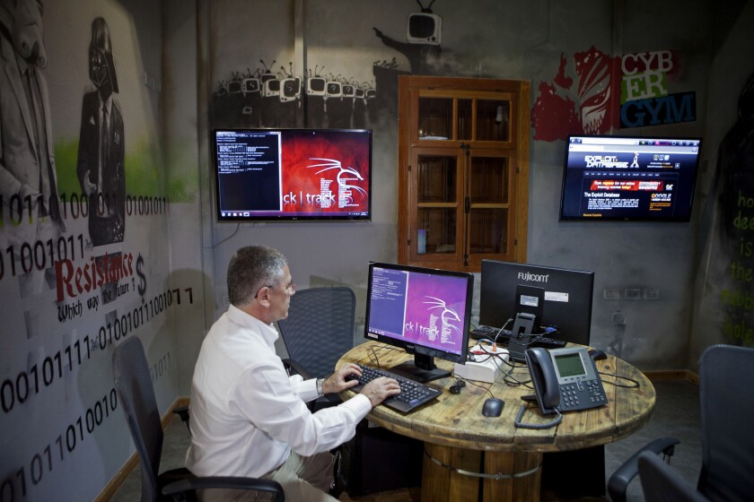 Yasha Hain, a vice president at Israel Electric Corp., is shown working on a computer at the utility company's "CyberGym" training facility in Hadera, Israel.