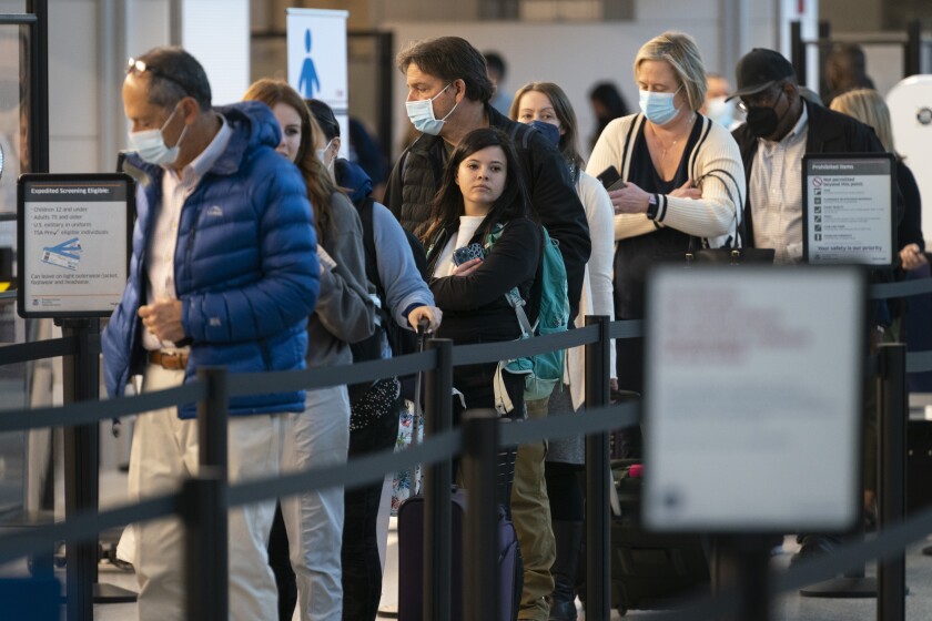 Passengers wait in line at the security checkpoint at Ronald Reagan Washington National Airport