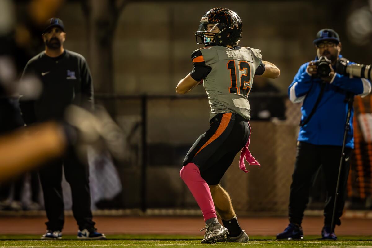 Huntington Beach's Steel Kurtz throws a lateral across the field on the opening kick-off to Troy Foster against La Habra.