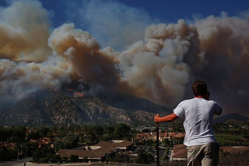 Trever Antrin watches as the Spring fire burns near Camarillo Springs.