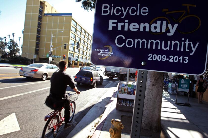 A cyclist rides past the Santa Monica Bike Center on Colorado Blvd. in Santa Monica.