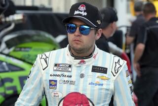 FILE - Noah Gragson walks to his garage during a practice session for the NASCAR Daytona 500.