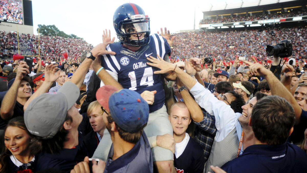 Mississippi quarterback Bo Wallace is carried off the field by fans after a 23-17 upset win over Alabama on Saturday.