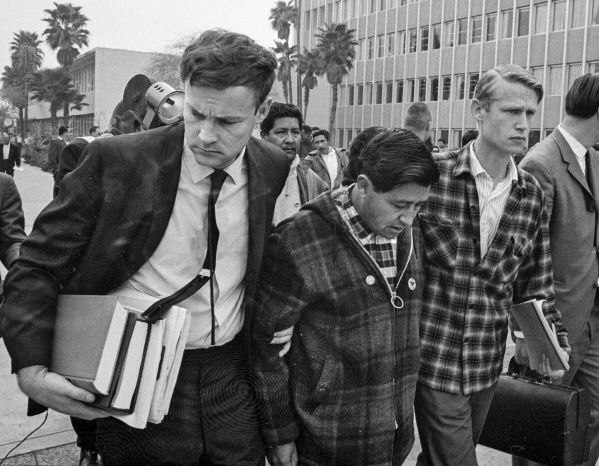 Feb. 26, 1968: Weakened by a 12-day fast, Chavez is helped from a Bakersfield courthouse by union attorney Jerry Cohen, left, and Leroy Chatfield, a union aide.