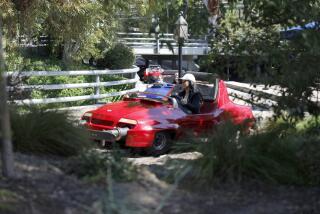 Anaheim, CA - March 11: Visitors ride the Disneyland Monorail passes by Tomorrowland in the background at Disneyland in Anaheim Monday, March 11, 2024. (Allen J. Schaben / Los Angeles Times)