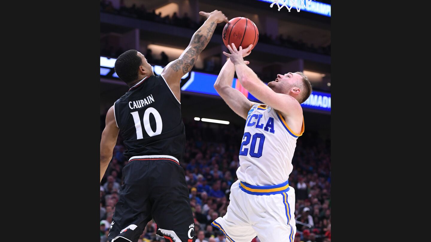 UCLA guard Bryce Alford scores against Cincinnati guard Troy Caupain during the second half.