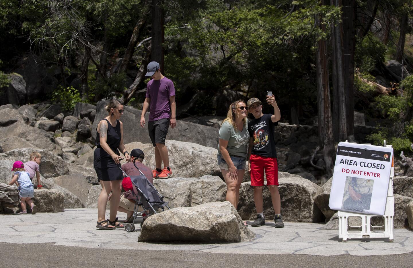 Visitors take photos at Lower Yosemite Falls.
