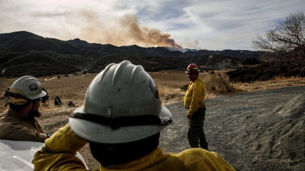 A crew from the Four Corners region of Arizona monitors the Thomas blaze, which has burned more than 280,000 acres, on Christmas.
