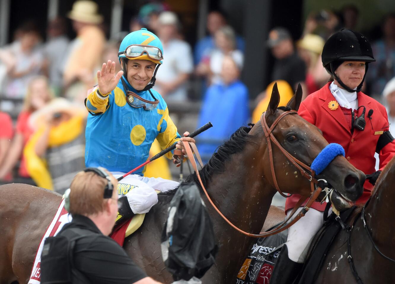 Victor Espinoza, aboard American Pharoah, waves after the 140th Preakness at Pimlico Race Course.