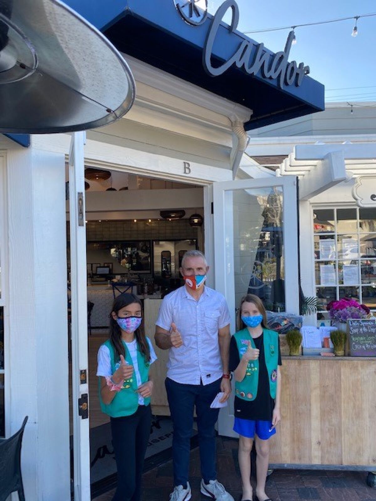 Girl Scout Sabrina Hochberg, Candor owner Giuseppe Ciuffa and Girl Scout Brenna Olmert