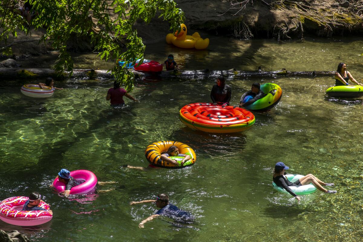 BIG SUR, CA - MAY 02: Campers keep cool on colorful inner tubes on the Big Sur River in Pfeiffer Big Sur State Park on Sunday, May 2, 2021 in Big Sur, CA. (Brian van der Brug / Los Angeles Times)