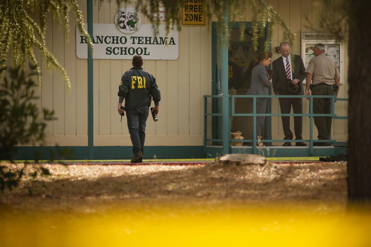 FBI agents outside Rancho Tehama Elementary School after a shooting rampage left at least four dead and 10 injured in the Northern California community.