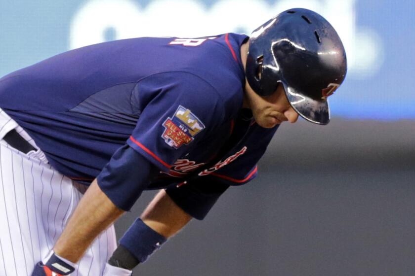 Minnesota Twins first baseman Joe Mauer reacts after suffering an injury during Tuesday's game against the Kansas City Royals.