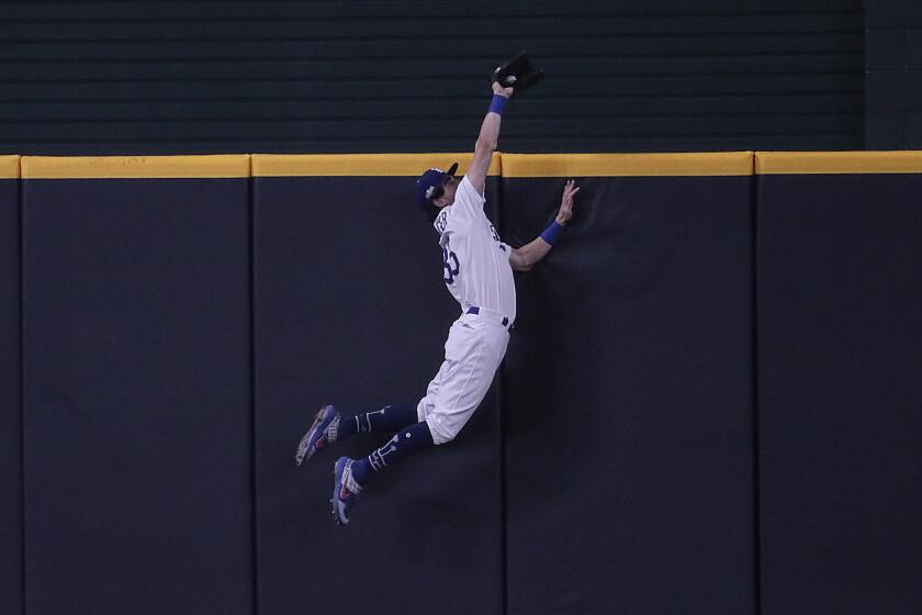 Arlington, Texas, Wednesday, October 7, 2020. Los Angeles Dodgers center fielder Cody Bellinger (35) robs Fernando Tatis Jr. of a seventh inning homer in game two of the NLDS at Globe Life Field. (Robert Gauthier/ Los Angeles Times)