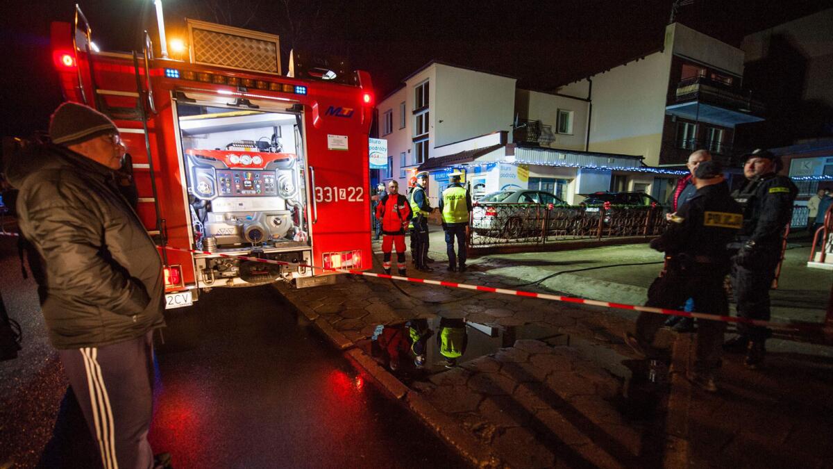 Police and firefighters at the scene where a fire broke out at an “escape room” in the northern Polish city of Koszalin on Wednesday, leaving five teenage girls dead and one man injured.