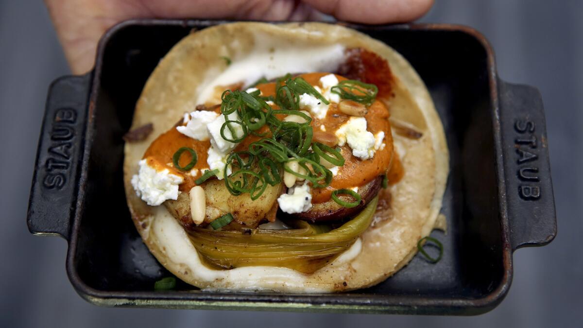 Wes Avila of Guerrilla Tacos shows his sweet potato breakfast taco. Avila will open a brick-and-mortar version of his taco truck in the downtown Arts District next summer.