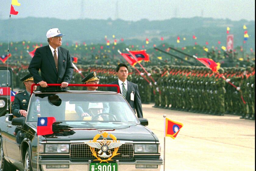 Taiwanese President Lee Teng-hui rides in an an open limousine as he inspects armored divisions during a combined forces mobilization exercise at Lungtan Army Base in northern Taoyuan county in 1997.