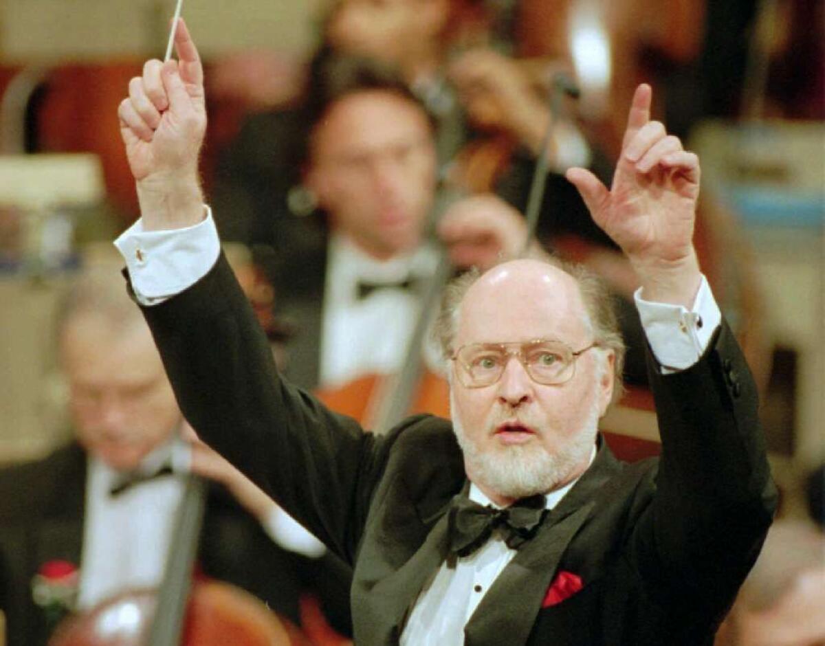 John Williams conducts the Boston Pops Holiday Concert at Boston Symphony Hall Monday evening, Dec. 20, 1993, as he makes his last appearance after 14 years as conductor of the Boston Pops.