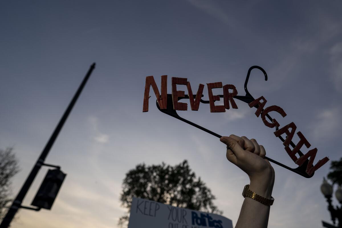 Pro-choice demonstrators hold signs in front of the Supreme Court in Washington on May 3.