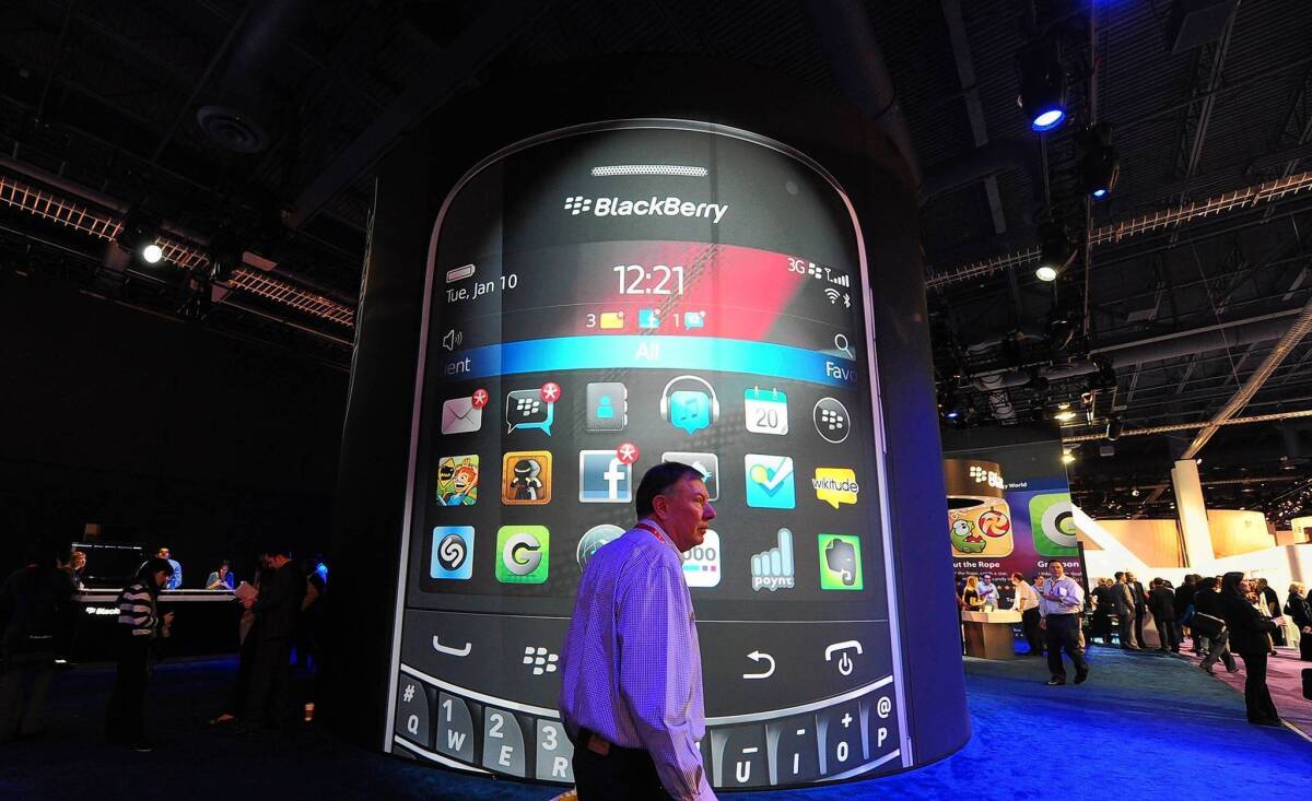A man walks past a BlackBerry display at the 2012 International Consumer Electronics Show in Las Vegas. BlackBerry maker Research in Motion has lost significant share in the U.S. and other crucial markets in the last few years as consumers flocked to other smartphones.