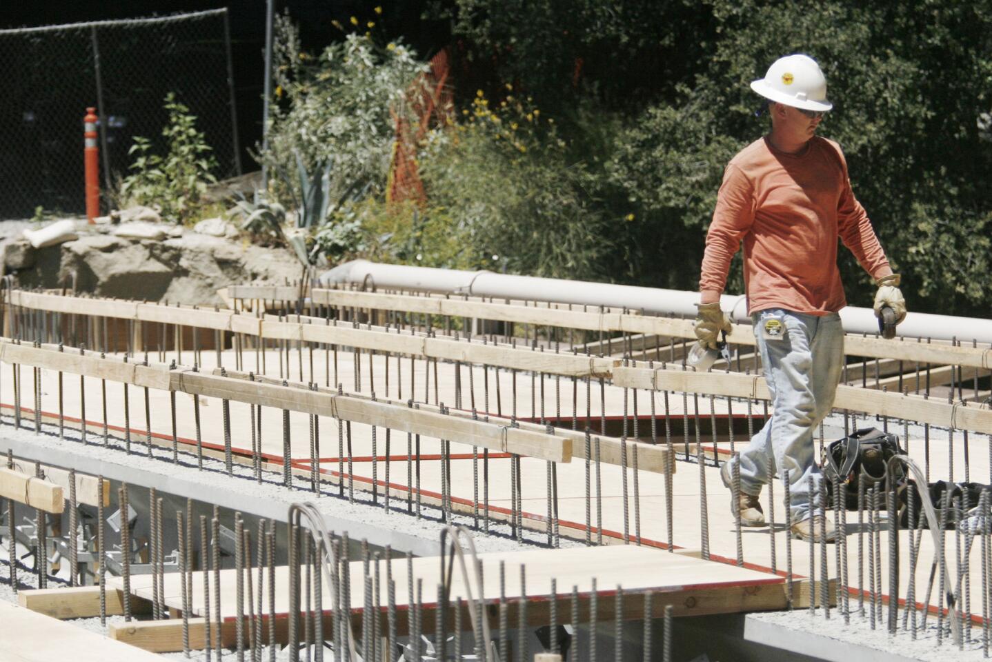 Construction workers reconstruct a bridge on Jessen Dr. in La Canada on Wednesday, June 27, 2012.