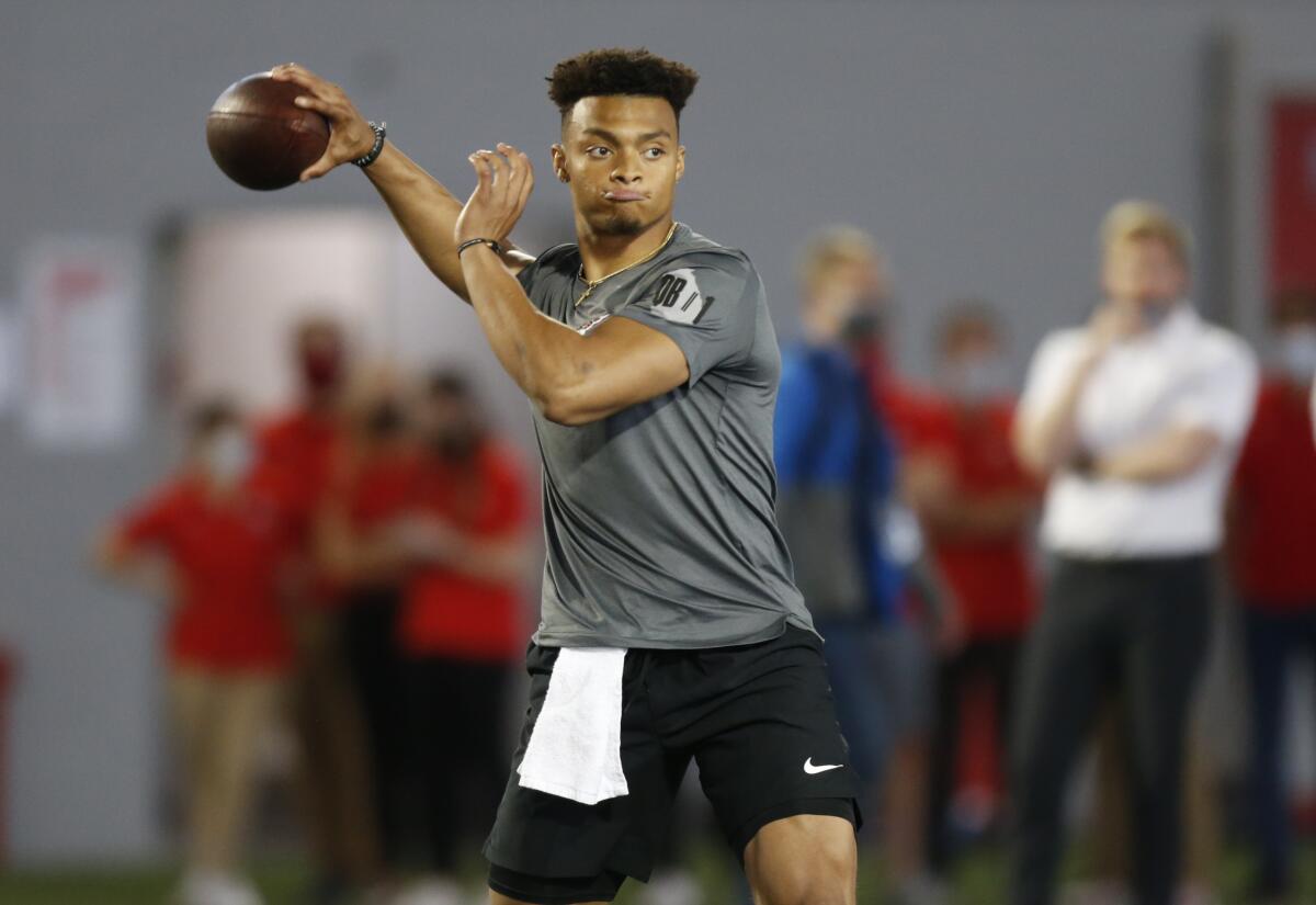 FILE - Ohio State quarterback Justin Fields throws during an NFL Pro Day at Ohio State University in Columbus, Ohio, in this Tuesday, March 30, 2021, file photo. The Division I Council meets Wednesday and Thursday, April 14-15, and at the top of the agenda — at least in terms of importance — is voting on a proposal that would grant all college athletes the right to transfer one time as undergraduates without sitting out season of competition. Some high-profile players such as quarterback Justin Fields, who transferred from Georgia to Ohio State in 2019, were granted waivers by the NCAA and it created an expectation that all players would be cleared to play right away. (AP Photo/Paul Vernon, File)