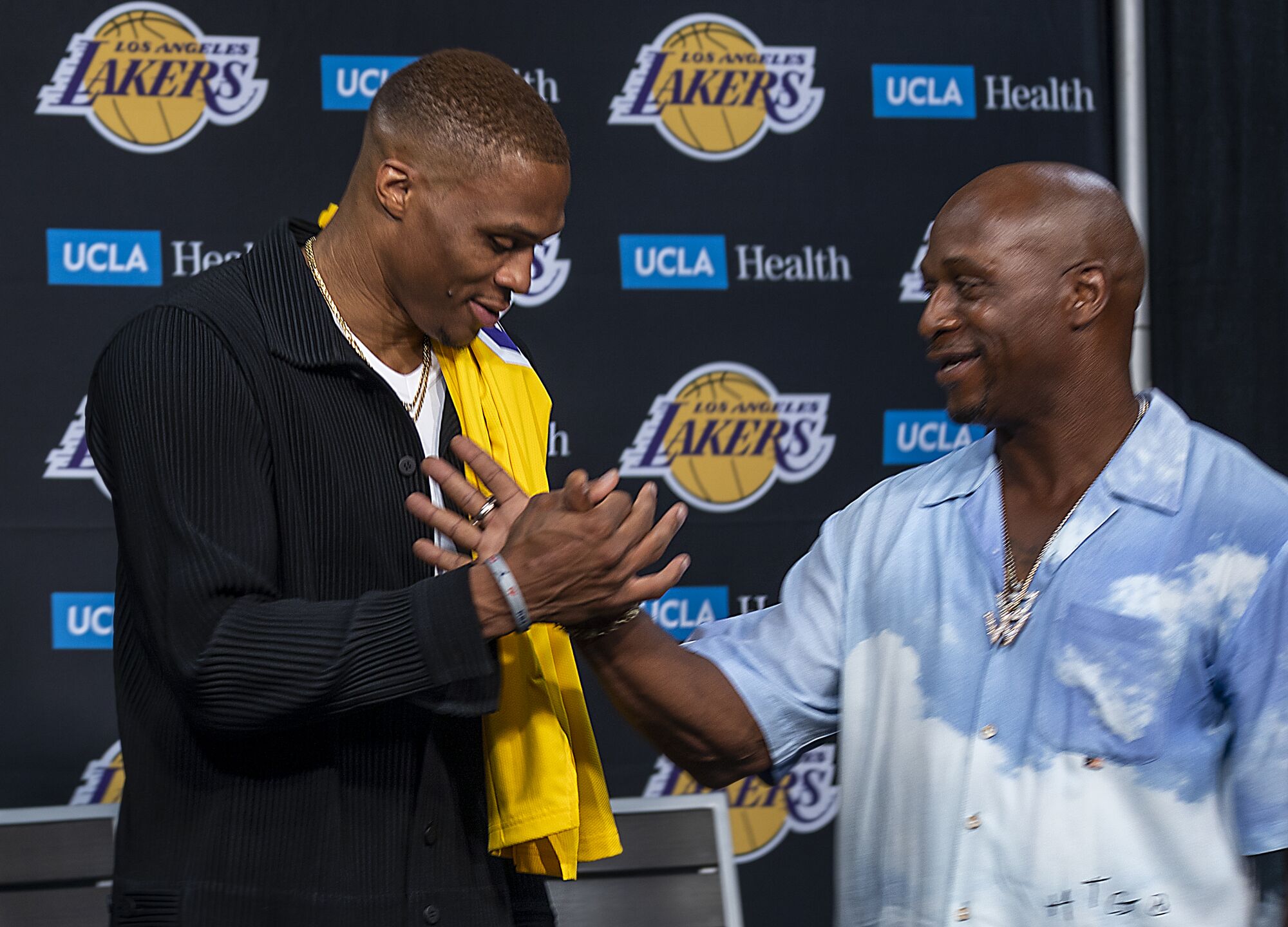 Russell Westbrook is greeted by his father, Russell, after receiving with his new Lakers jersey .
