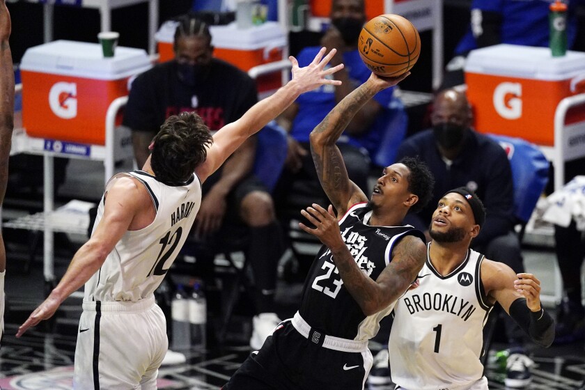 Clippers guard Lou Williams pulls up for a shot over Nets guard Joe Harris.