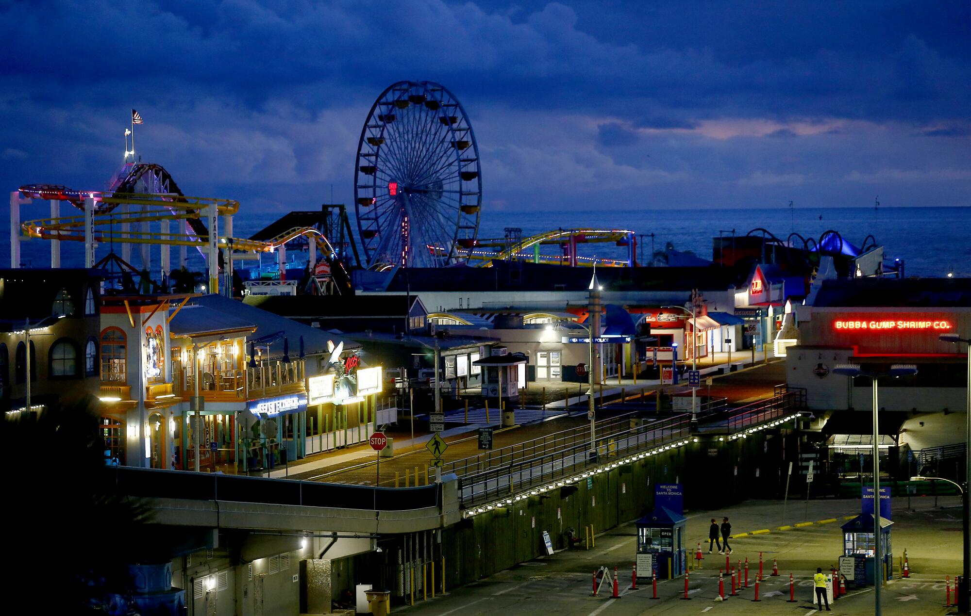 The lights are on but the Santa Monica Pier is closed to the public.