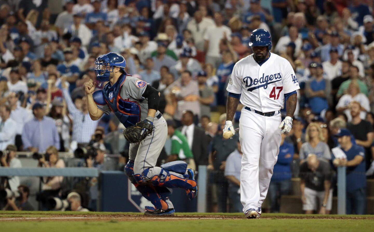 Mets catcher Travis d'Arnaud runs to celebrate with teammates after Dodgers second baseman Howie Kendrick struck out to end Game 5 of the National League division series on Thursday night at Dodger Stadium.