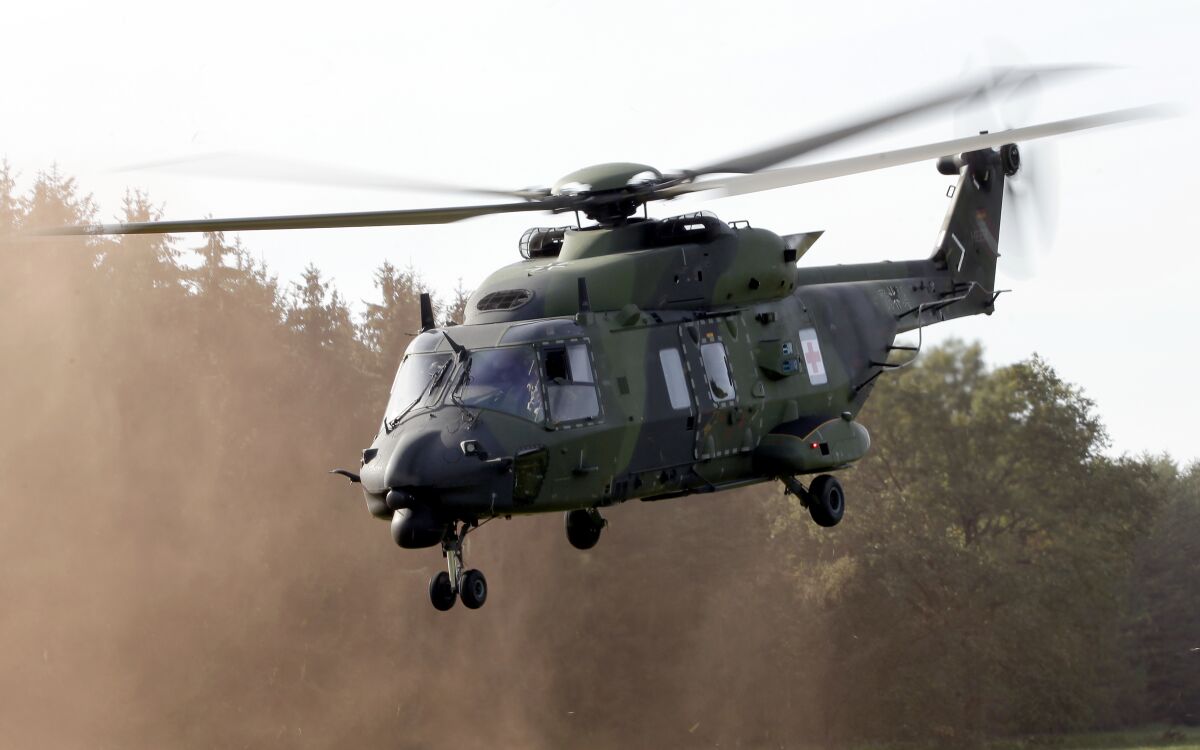 FILE - A NH90 multipurpose helicopter takes off during a demonstration event held for the media by the German Bundeswehr in Bergen near Hannover, Germany, Wednesday, Sept. 28, 2011. NATO-member Norway has terminated its contract for 14 NH90 helicopters, citing delays, errors, time-consuming maintenance, will return all choppers while demanding full refund of the nearly 5 billion ($525 million) kroner, the defense minister said Friday, June 10, 2022. (AP Photo/Michael Sohn, File)