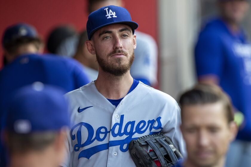 Los Angeles Dodgers' Cody Bellinger looks over in the dugout before a baseball game.