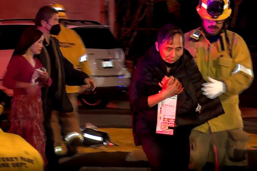 Firefighters attend to victims injured during a mass shooting 