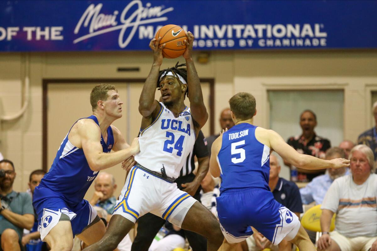 UCLA's Jalen Hill works in the post against a double team during a Maui Invitational game against Brigham Young in 2019.