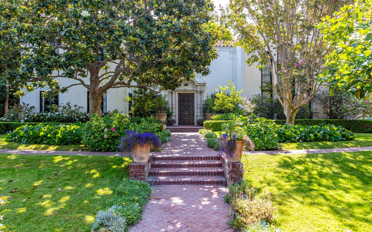 The 100-year-old home holds six bedrooms, eight bathrooms, a two-story entry, dramatic dining room and grand ballroom that doubles as a movie theater.