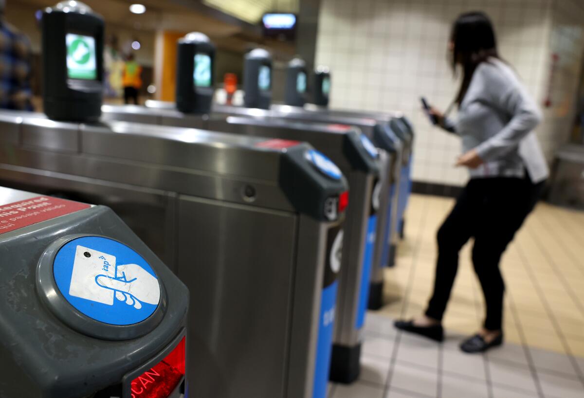A rider taps her card to gain entry to the train platform at the North Hollywood Metro station on May 29.