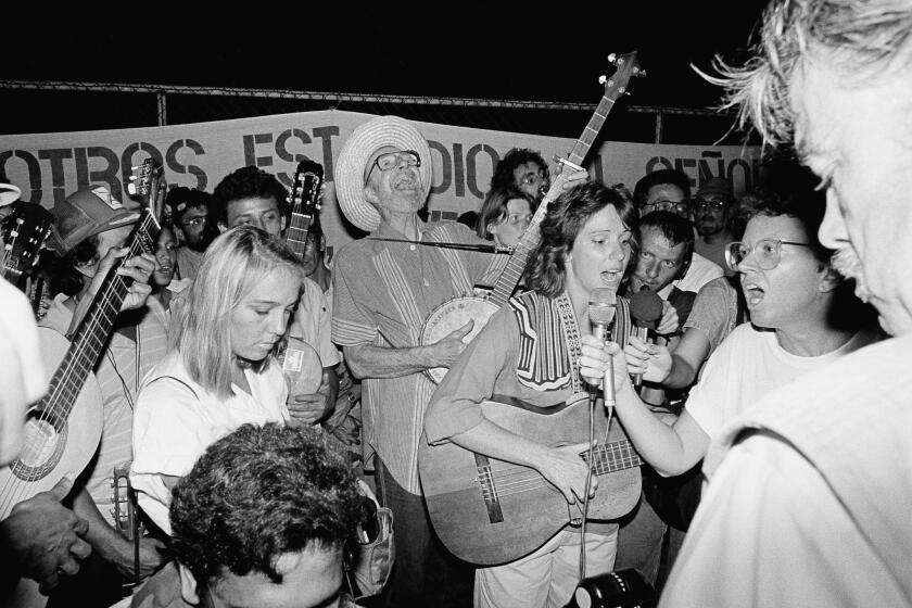 Seeger joins in a song at a 1988 rally outside the U.S. Embassy in Managua, Nicaragua. The gathering was to protest U.S. aid going to the Nicaraguan Contra rebels.