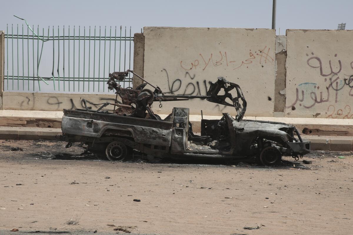 A destroyed military vehicle is seen in southern in Khartoum, Sudan
