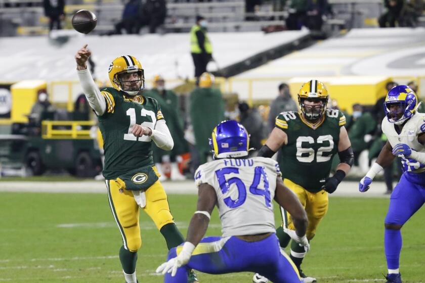 Packers quarterback Aaron Rodgers passes against the Rams during the second half Jan. 16, 2021, in Green Bay, Wis.