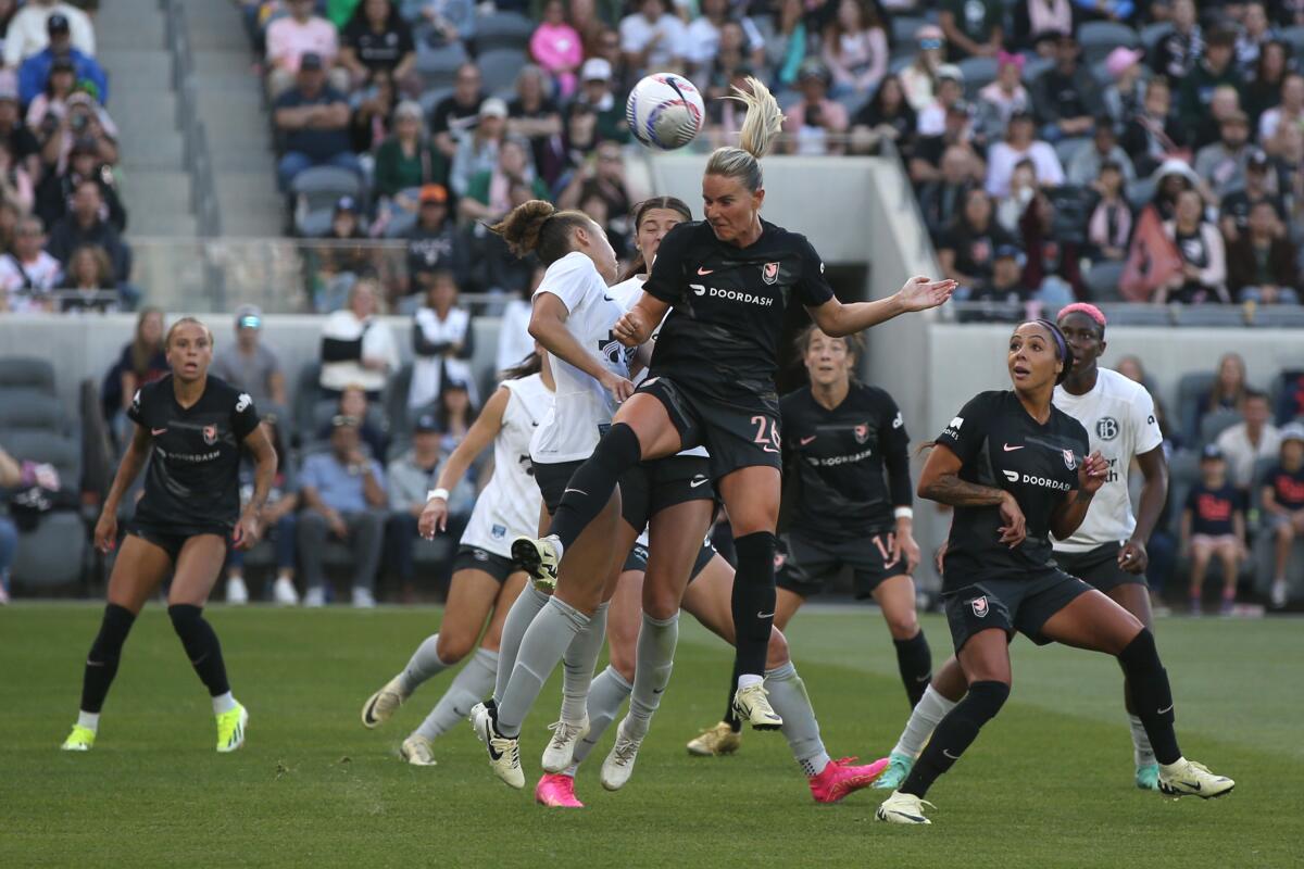 Angel City's Amandine Henry heads a ball off a corner kick against Bay FC.