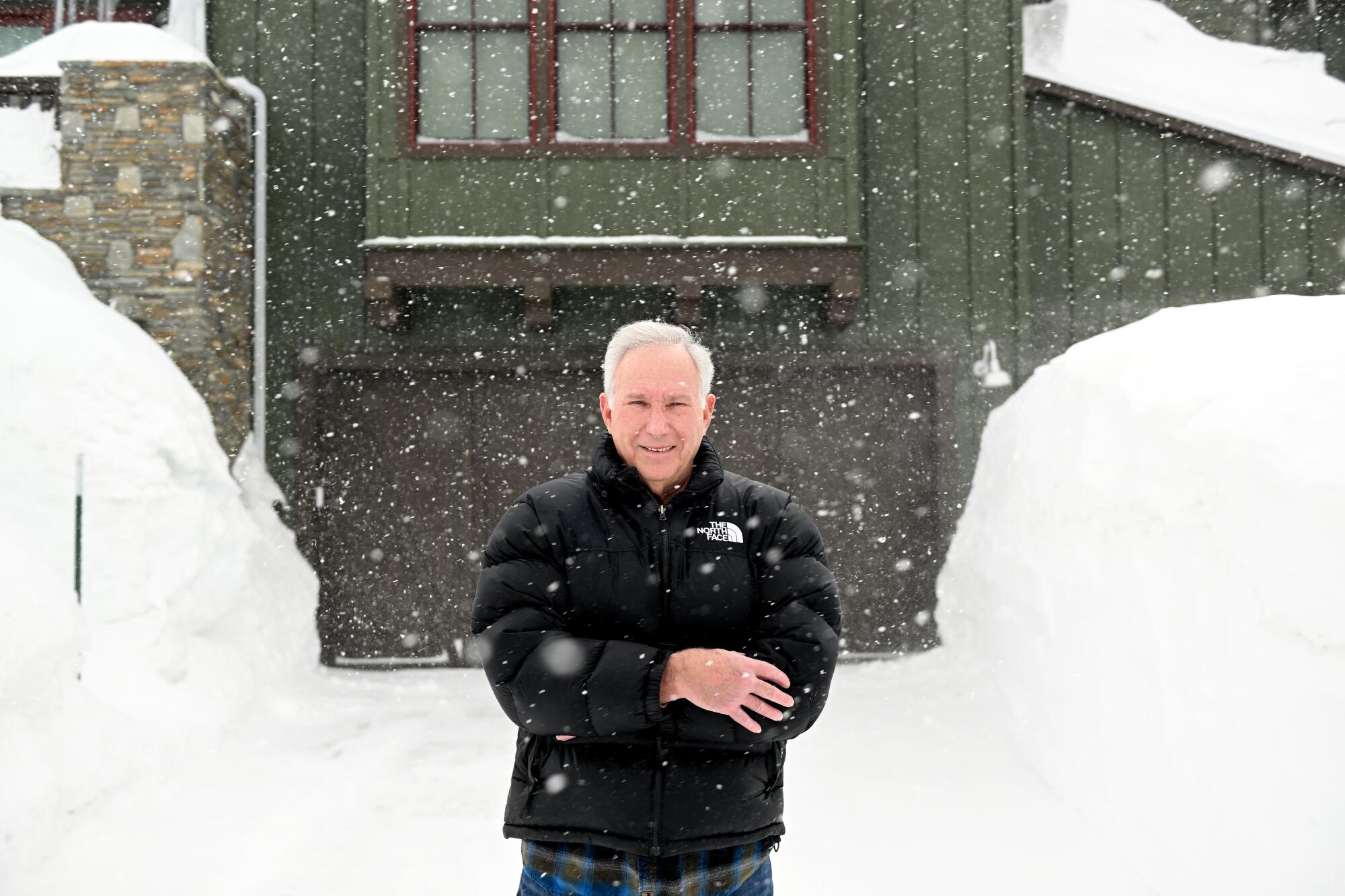 Local meteorologist Howard Scheckter stands in front of his house in Mammoth Lakes.