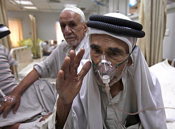 An Iraqi man is treated for breathing problems after a dust storm in Baghdad. Even the slightest wind can whip up a pall of dust that lingers for days.