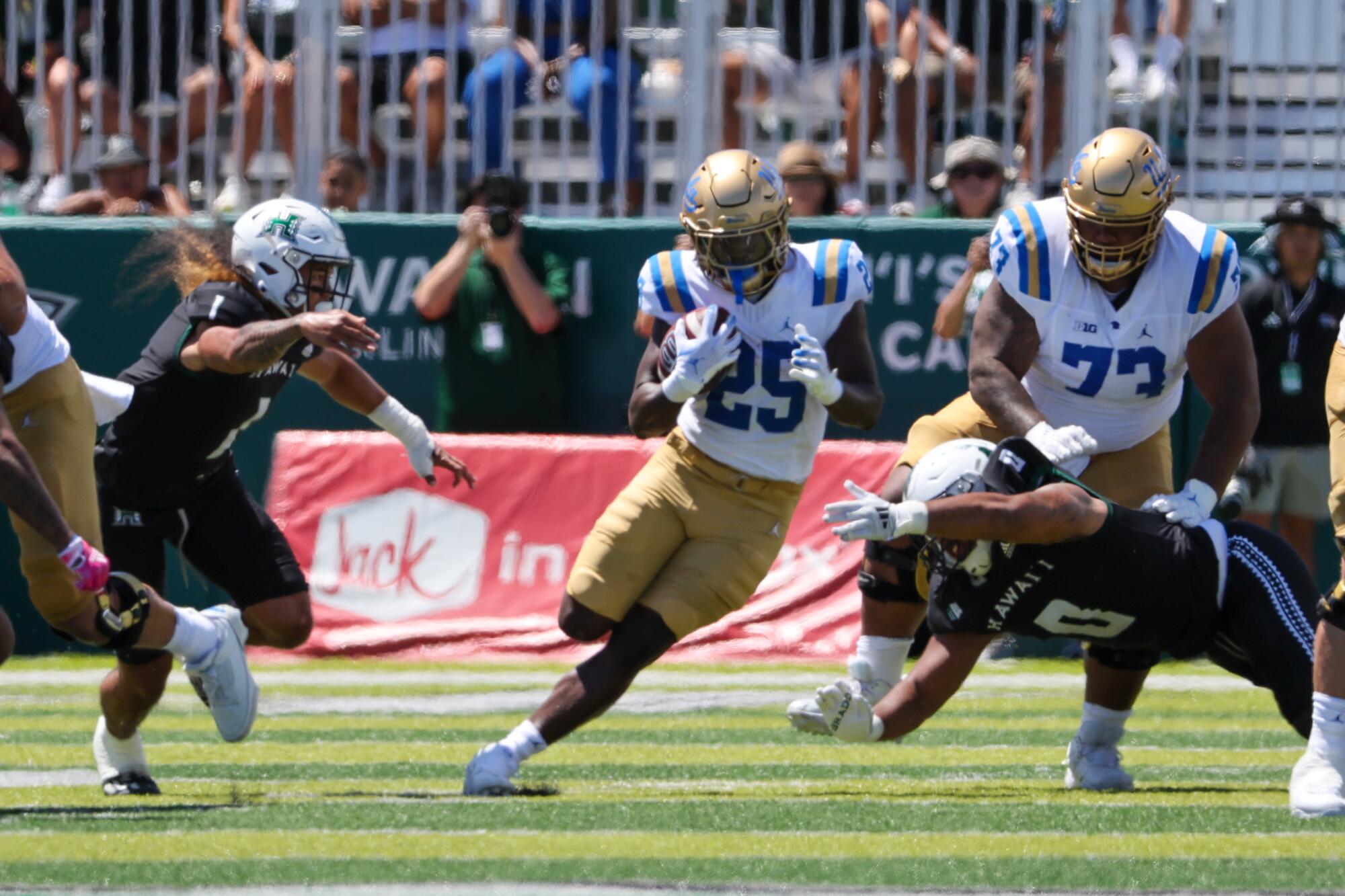 UCLA running back T.J. Harden carries the ball in the first half of the Bruins' 16-13 comeback victory.