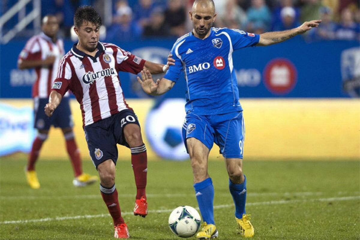Chivas USA's Carlos Alvarez, left, challenges Montreal Impact's Marco Di Vaio for the ball during the second half of a match in July.