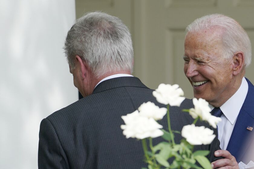 FILE - President Joe Biden, right, talks with House Minority Leader Kevin McCarthy of Calif., left, after an event in the Rose Garden of the White House in Washington, July 26, 2021. The president and the House speaker are preparing for their first official visit at the White House on Wednesday, ahead of a looming debt crisis. (AP Photo/Susan Walsh, File)